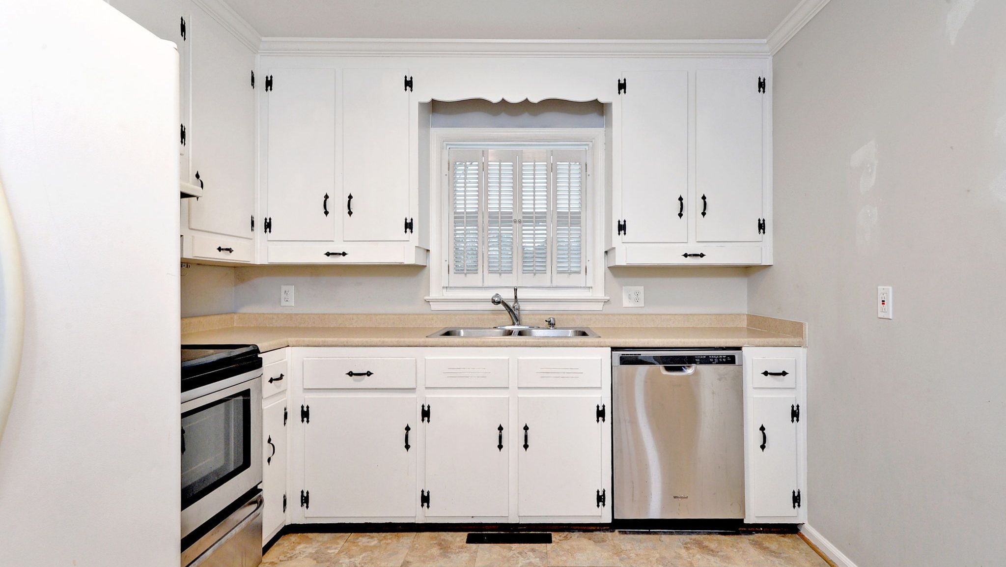 professional real estate photographer capturing white kitchen with new cabinets in new listing in newport news virginia